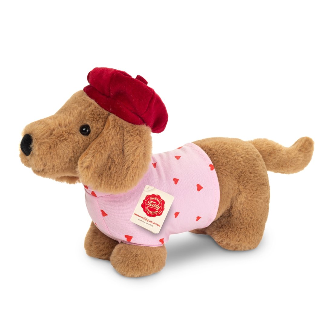 Hermann TEDDY Herzekind Dackel Claude aus braunem Plüsch mit Herzchenshirt und roter Mütze